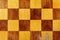 Fragment of a old wooden chess board closeup. Abstract background