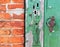 Fragment of the old wooden door with multiple keyholes and a rusty vintage handle