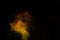 Fragment of orange yellow steam smoke isolated on a black background, close-up. Create mystical Halloween photos