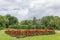 Fragment of park with flower bed and shaped trees