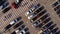 A fragment of a parking lot with cars and pedestrian crosswalk. Aerial.