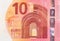 Fragment part of 10 euro banknote close-up with small red details