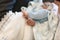A fragment of a photograph of a little boy preparing for a baptismal ceremony, legs on a white blankets, baptism
