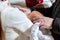 A fragment of a photograph of a little boy preparing for a baptismal ceremony, legs on a white blankets, baptism