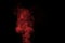 Fragment of red steam smoke isolated on a black background, close-up. Create mystical Halloween photos