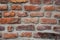 Fragment of the restoration of masonry of old red brick. different size and color bricks, background, screensaver place for text,