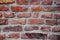 Fragment of the restoration of masonry of old red brick. different size and color bricks, background, screensaver place for text,