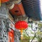 Fragment of rich decoration wall and roof famous Po Lin Monastery with carved chinese mythical dragons and traditional red paper l