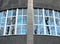 Fragment of roundish wall with big windows overlooking park