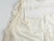Fragment of a silk beige blouse with lace and buttons
