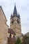 Fragment of small square with clocktower of Lutheran Cathedral of Saint Mary in a rainy day in Sibiu city in Romania