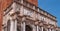 Fragment of St Mark`s Campanile - famous bell tower of St Mark`s Basilica and Loggetta. Piazza San Marco, Venice, Italy