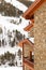 Fragment of the stone house at a mountain slope in the winter