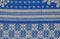 A fragment of the texture of a white-blue tablecloth made in the 1960s in Ukraine. Traditional national ornament