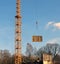 Fragment of a tower of a lifting tower crane and the moved freight