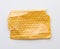 Fragment of a transparent film with air for transportation of parcels is glued on a yellow sheet of paper