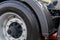 Fragment of a truck wheel close-up. Clean truck tire. Rubber tire, steel wheel rim and plastic mudguard