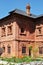 Fragment of a two-storey red brick house.