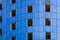 Fragment of an unfinished building under construction with blue cladding panels