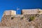 Fragment of the wall of the Venetian fortress and the Greek flag in the city of Chania