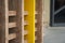 A fragment of the wall of a wooden cafe made of yellow boards. Wooden beams in the groove. A fragment of a wall at the