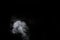 Fragment of white hot curly steam smoke isolated on a black background, close-up. Create mystical photos. Abstract