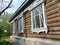 A fragment of the wooden facade hut. The window architraves. Folk art. Russian village. Old wooden houses