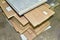 Fragment of a wooden panel made of fiberboard in workshop. Medium Density Fiberboard MDF. Woodworking industry and furniture