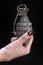 fragmentation grenade in girl hand