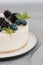 Fragments of classic cheesecake with fresh berries on a gray background.