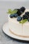 Fragments of classic cheesecake with fresh berries on a gray background.