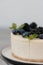 Fragments of classic cheesecake with fresh berries on a gray background.