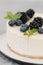 Fragments of classic cheesecake with fresh berries on a gray background.