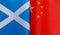 Fragments of national flags of Scotland and China close-up