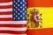 Fragments of the national flags of the United States and Spain close-up concept