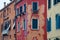 Fragments of old Venetian buildings with peeling plaster, red, light yellow, orange.