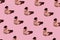Fragnance parfume pattern. Bottles of pink woman perfume on a pastel pink background, top view. Mockup of fragrance perfume.