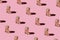 Fragnance parfume pattern. Miniature bottles of pink woman perfume on a pastel pink background, top view. Mockup of fragrance