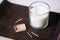 Fragrance candle and matches on tray on table