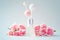 Fragrance diffuser and pink flowers on vintage blue background