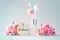 Fragrance diffuser with welcome tag and pink carnation flowers on vintage blue background