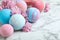 Fragrant bath bombs and sakura flowers on white marble table, closeup