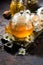 fragrant chamomile tea in a glass teapot, vertical closeup