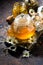 Fragrant chamomile tea in a glass teapot, vertical top view