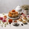 Fragrant Chrysanthemum tea in a teapot with savory snacks on table