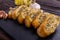 Fragrant garlic bread on a dark stone plate