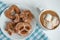 Fragrant gingerbread cookies on a white plate with a cup of warm cocoa or coffee with marshmallow, sprinkled with chocolate