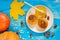 Fragrant golden pumpkin pancakes with honey and walnuts on a blue wooden background.