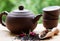 Fragrant herbal tea with flower petals, a kettle and cups