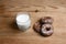 Fragrant honey gingerbreads, cakes and a glass of milk on a wooden background, top view, natural food